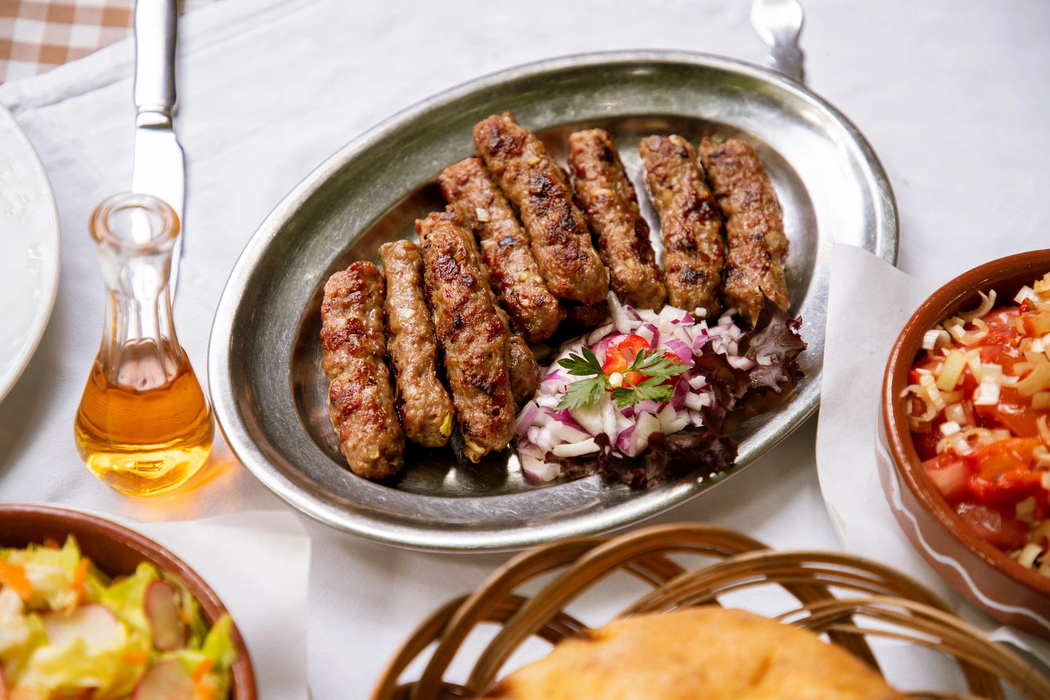Ground beef kebabs plated with onion